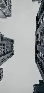 Minimalist wallpaper of urban skyscrapers against a gray sky.