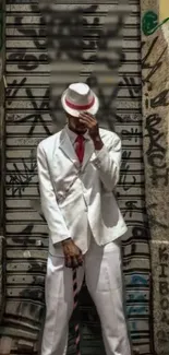 Stylish figure in white suit with graffiti background.