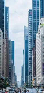 Urban street with skyscrapers under a blue sky.