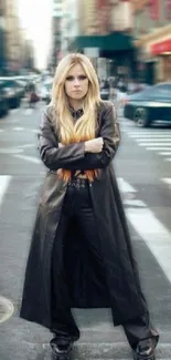 Stylish person in a long leather coat on a bustling city street.