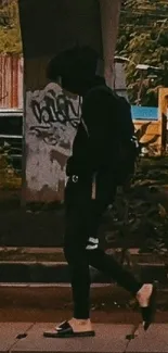 Person in urban street style walking under a bridge.