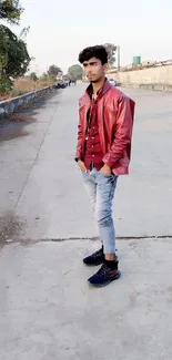 Person in red jacket standing on empty street.