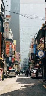 Bustling urban street with colorful signs and modern buildings.