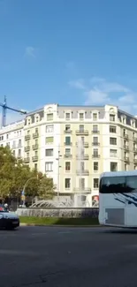 City street view with a fountain and historic building under a blue sky.