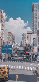 Vibrant city street with skyscrapers and blue sky.