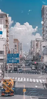 High-angle view of a busy urban street with blue sky and clouds.