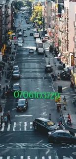 High-angle view of a busy city street with cars and pedestrians.