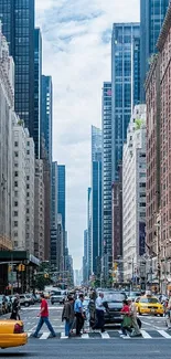 Vibrant city street with yellow taxis and skyscrapers.