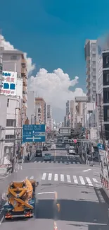 Urban street with skyscrapers and blue sky wallpaper.