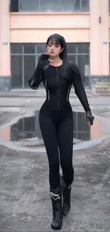 Woman in sleek black athletic wear walking confidently in an urban setting.