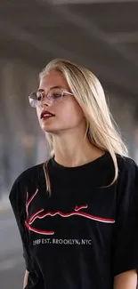 Urban wallpaper with stylish person in black T-shirt under a city bridge scene.