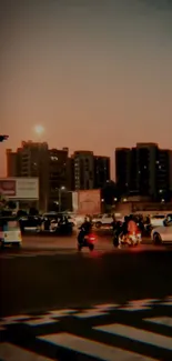 Urban street scene at sunset with city traffic and tall buildings.