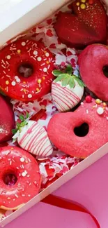 Valentine themed red donuts in box with pink background.