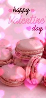 Valentine's Day wallpaper with pink macarons and heart decorations.