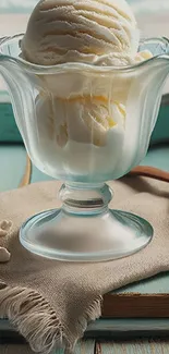 Vanilla ice cream in elegant glass cup on table.
