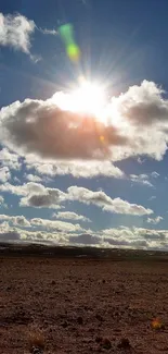 Sunny desert landscape with clouds and blue sky wallpaper.