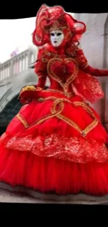 Venetian mask figure in red costume by a bridge.