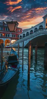 Gondola on Venice canal under a fiery sunset sky.