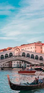 Venice canal with gondolas under a blue sky and historic bridge.