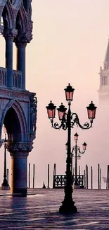 Venice street scene with iconic architecture and street lamps in misty dusk.