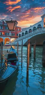 Venice gondola with Rialto Bridge at sunset