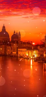 Vibrant orange Venice sunset over the Grand Canal, with domed architecture.