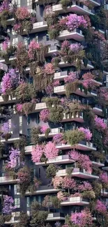 Mobile wallpaper of a vertical garden building with vibrant pink and green foliage.