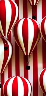 Red and white striped hot air balloons on a mobile wallpaper.
