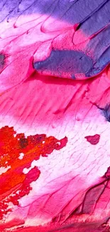 Abstract vibrant texture with pink, red, and purple hues.