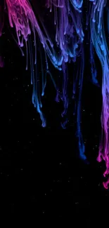 Colorful abstract ink swirls on black background.