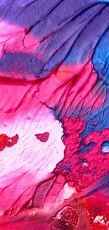 Vibrant abstract wallpaper with pink, red, and blue brushstrokes.