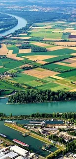 Aerial view of green fields and winding river landscape.