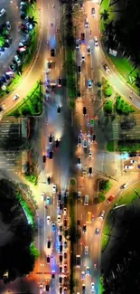 Aerial view of illuminated highway intersection at night.