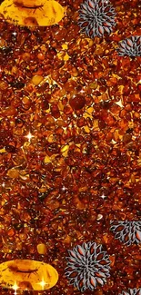 Amber stones with silver flower accents on a phone wallpaper.