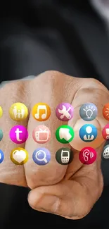 Hand pointing with colorful app icons on the screen.