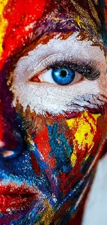 Vibrant painted face with striking blue eye close-up wallpaper.