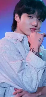 Thoughtful individual in a white shirt with artistic tattoos on a blue-purple background.