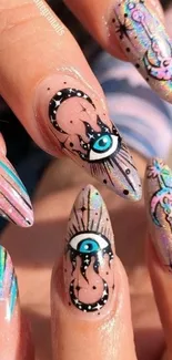 Colorful nail art with eye design on beige background.