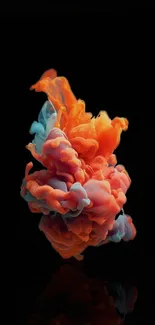 Vibrant orange and blue smoke cloud on black background.