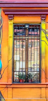 Vibrant graffiti art on an orange wall with a window in the center.