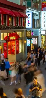 Vibrant Asian street with bustling pedestrians and colorful lights.