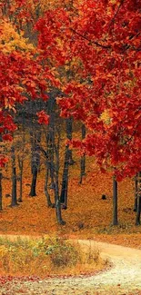 Vibrant autumn forest with red leaves and winding path.