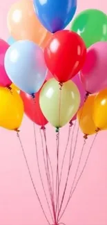 Colorful balloons against a pink background.