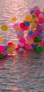 Colorful balloons floating on calm water surface.