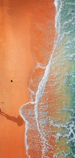 Aerial view of beach with orange sand and multicolored umbrella.