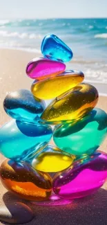 Colorful glass stones stacked on a sandy beach.