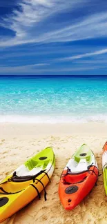 Colorful kayaks on a sunny beach with blue ocean waves under a clear sky.