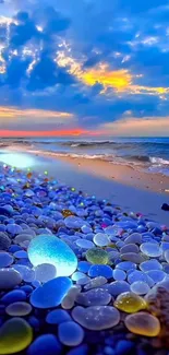 Colorful pebbles on beach under a vibrant blue sunset sky.