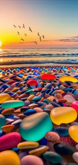 Vibrant pebble beach at sunset with birds flying over the ocean.