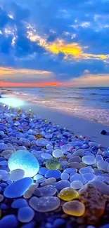 Vibrant beach pebbles under a stunning sunset sky.